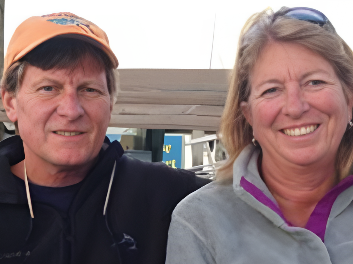 Smiling man and woman outdoors in casual clothing.